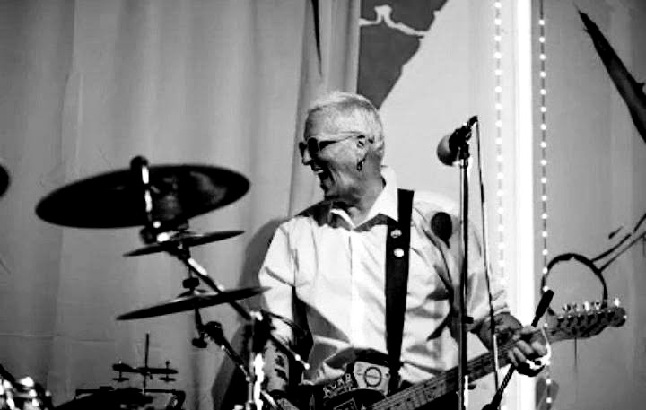 Bitzy performing on guitar and vocals